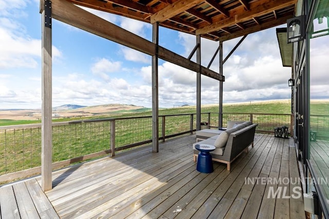 deck with a rural view and outdoor lounge area