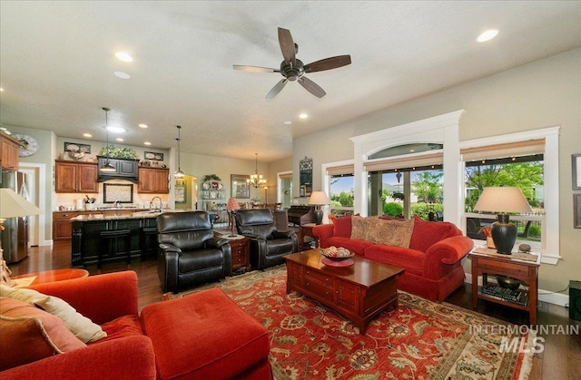 10318 W Adirondack Ct, Star, ID 83669 - living room with dark wood finished floors, recessed lighting, a ceiling fan, and a chandelier