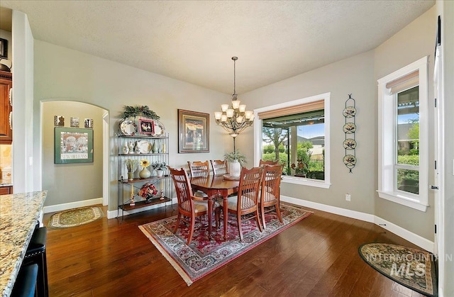 10318 W Adirondack Ct, Star, ID 83669 - dining room with a chandelier, dark wood-type flooring, and baseboards