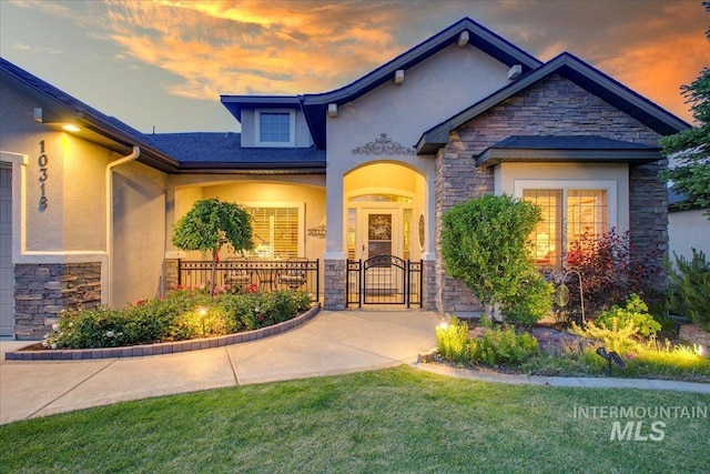 10318 W Adirondack Ct, Star, ID 83669 - craftsman-style home with stone siding, stucco siding, a gate, and a lawn