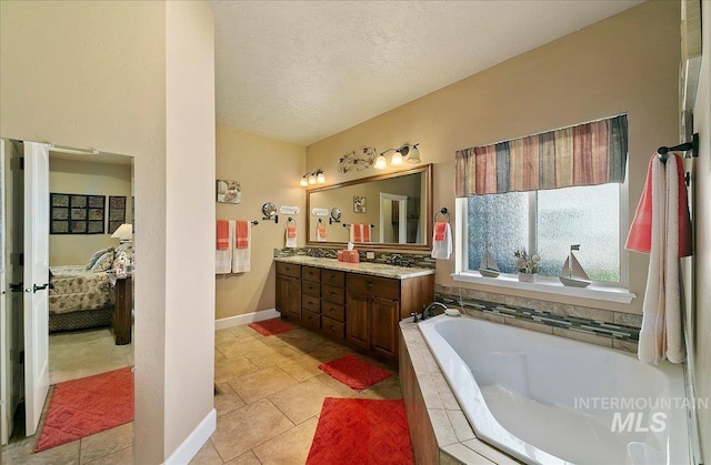 10318 W Adirondack Ct, Star, ID 83669 - bathroom with connected bathroom, double vanity, a bath, baseboards, and a textured ceiling