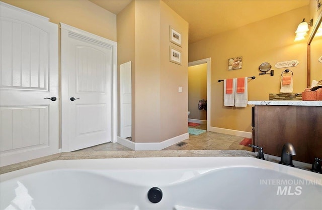 10318 W Adirondack Ct, Star, ID 83669 - full bath with baseboards, vanity, and a bathtub