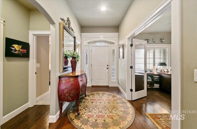 10318 W Adirondack Ct, Star, ID 83669 - foyer with dark wood-type flooring, arched walkways, and baseboards