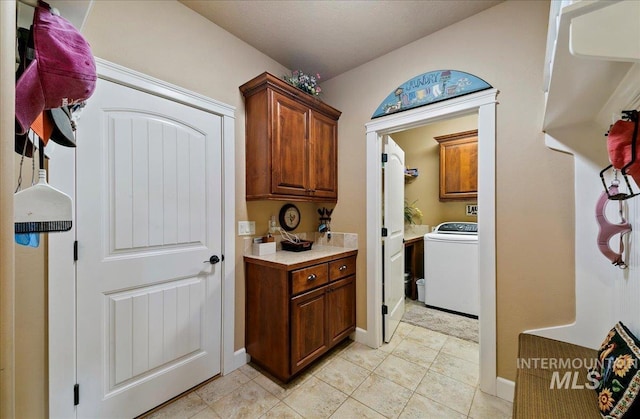10318 W Adirondack Ct, Star, ID 83669 - laundry room featuring washer / clothes dryer, cabinet space, light tile patterned floors, and baseboards