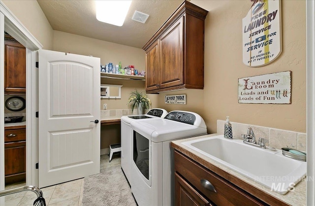 10318 W Adirondack Ct, Star, ID 83669 - laundry area with washer and clothes dryer, cabinet space, and light tile patterned floors