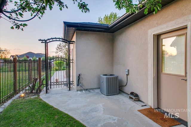 10318 W Adirondack Ct, Star, ID 83669 - patio terrace at dusk featuring central AC unit, a gate, and a patio
