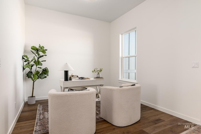 dining room with baseboards and wood finished floors