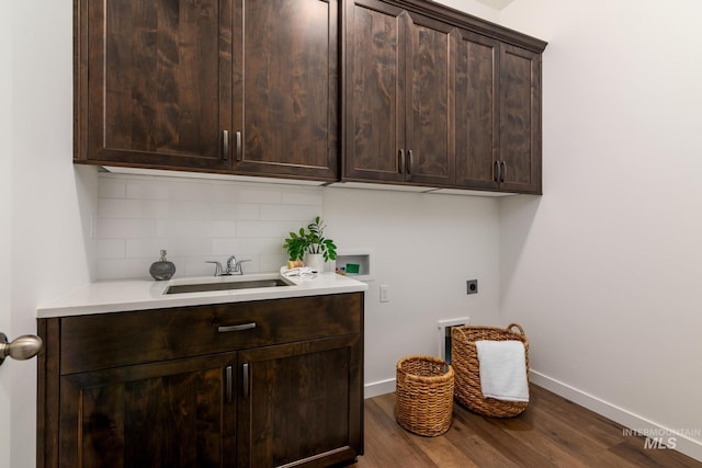washroom featuring washer hookup, dark wood finished floors, cabinet space, hookup for an electric dryer, and a sink