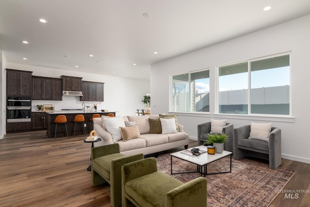 living room with baseboards, dark wood-style flooring, and recessed lighting