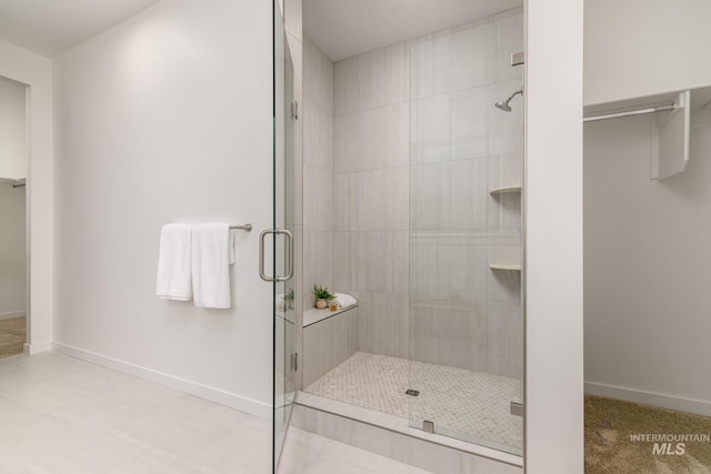 full bath with a stall shower and baseboards