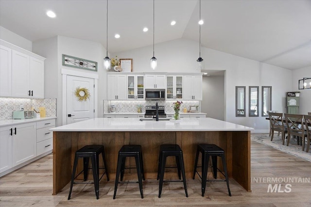 942 Paintbrush, Kimberly, ID 83341 - kitchen featuring appliances with stainless steel finishes, a sink, light countertops, white cabinetry, and high vaulted ceiling