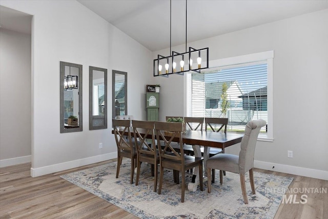 942 Paintbrush, Kimberly, ID 83341 - dining area with a chandelier, baseboards, wood finished floors, and a high ceiling