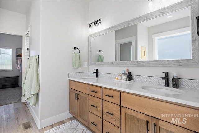 942 Paintbrush, Kimberly, ID 83341 - bathroom featuring wood finished floors, double vanity, and baseboards