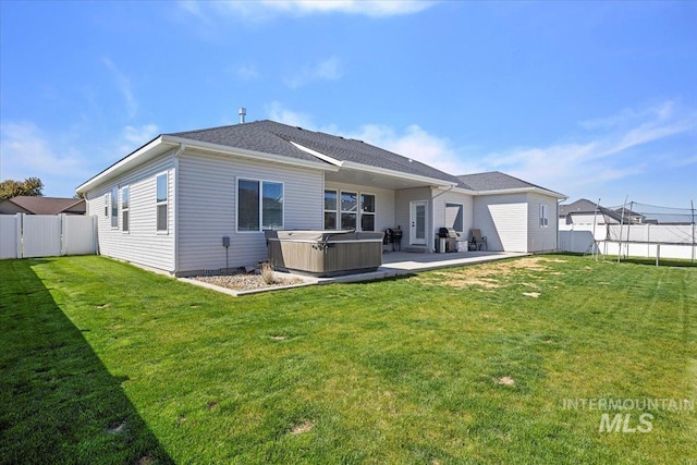 942 Paintbrush, Kimberly, ID 83341 - back of property with a hot tub, a trampoline, and a patio area