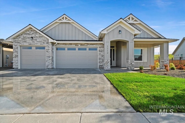 craftsman-style home featuring a garage and a front yard