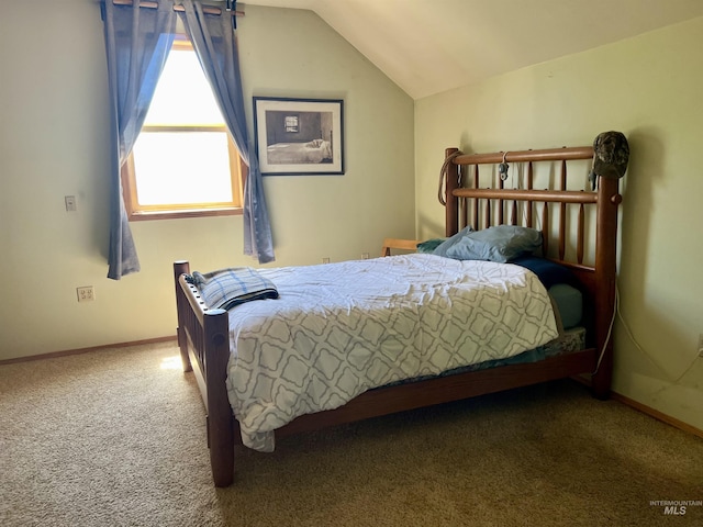 carpeted bedroom featuring vaulted ceiling