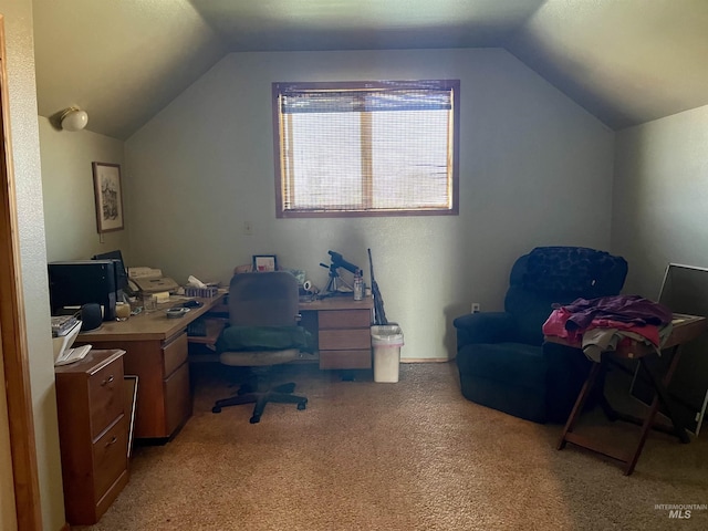 home office with light colored carpet and vaulted ceiling