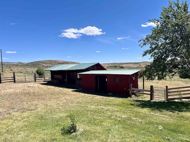 exterior space featuring a mountain view, a yard, and a rural view