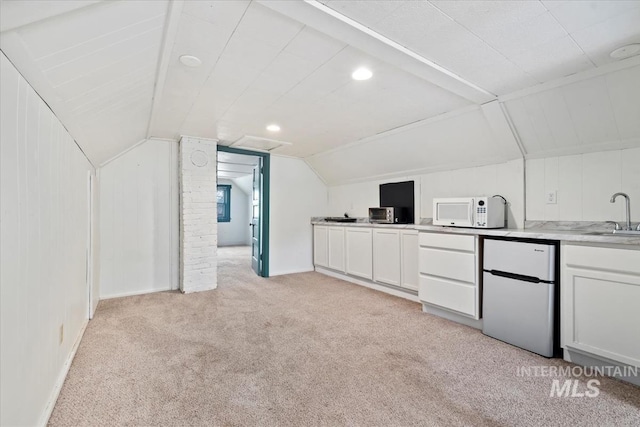 121 S Main St, Cascade, ID 83611 - additional living space with a sink, baseboards, vaulted ceiling, and light colored carpet