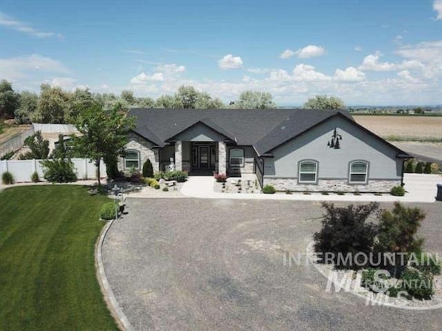 3847 N 2456 E, Filer, ID 83328 - view of front of house with stone siding, fence, and a front lawn