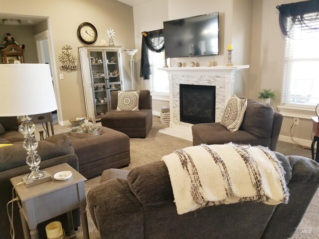 3847 N 2456 E, Filer, ID 83328 - living room featuring baseboards, carpet floors, a fireplace, and plenty of natural light