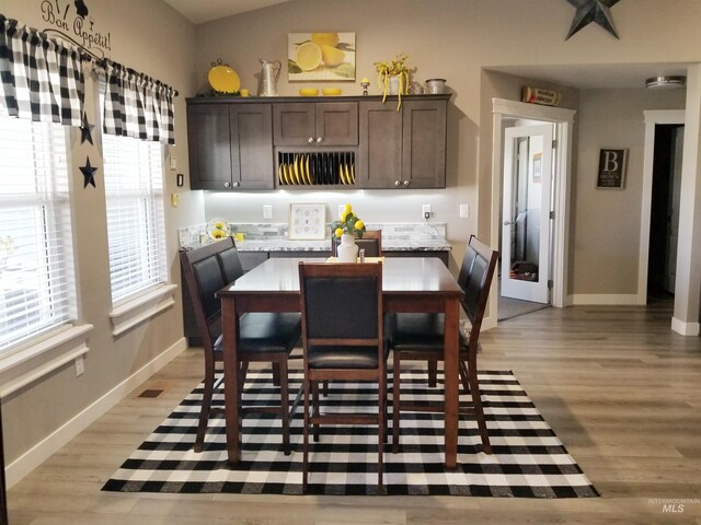 3847 N 2456 E, Filer, ID 83328 - dining room with baseboards, light wood-style floors, vaulted ceiling, and visible vents