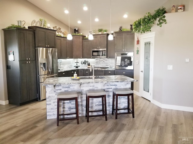 3847 N 2456 E, Filer, ID 83328 - kitchen featuring dark brown cabinets, a sink, stainless steel appliances, and a kitchen bar