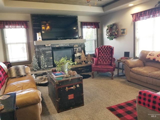 3847 N 2456 E, Filer, ID 83328 - carpeted living room featuring a raised ceiling and a fireplace