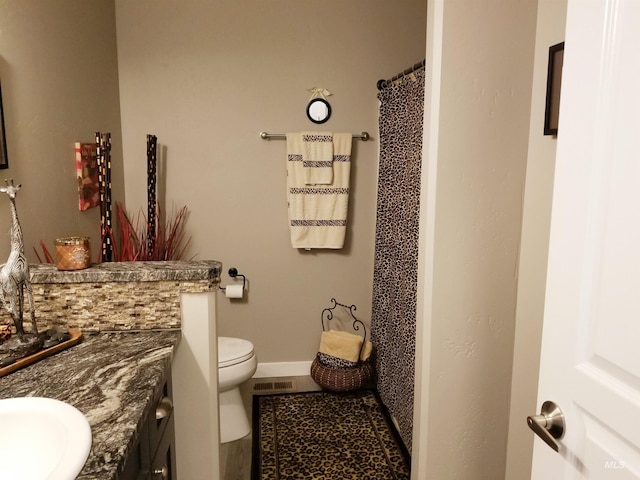 3847 N 2456 E, Filer, ID 83328 - bathroom with vanity, toilet, a shower with shower curtain, baseboards, and visible vents