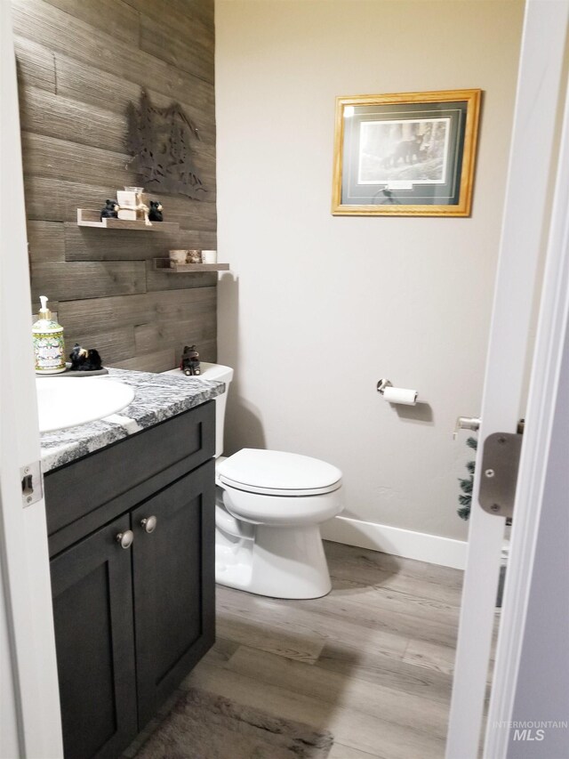 3847 N 2456 E, Filer, ID 83328 - half bathroom featuring baseboards, toilet, vanity, and wood finished floors