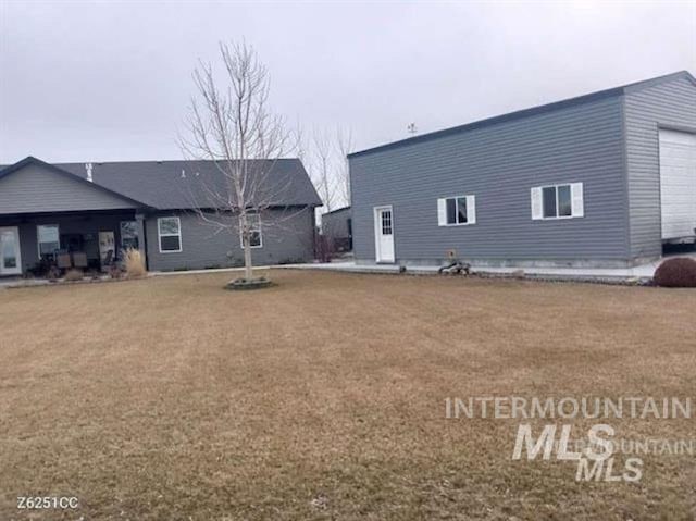 3847 N 2456 E, Filer, ID 83328 - rear view of property with a lawn and a garage
