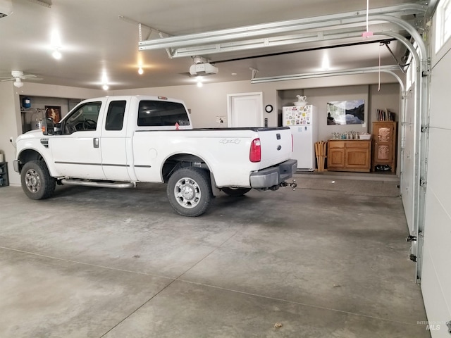 3847 N 2456 E, Filer, ID 83328 - garage featuring freestanding refrigerator and a garage door opener