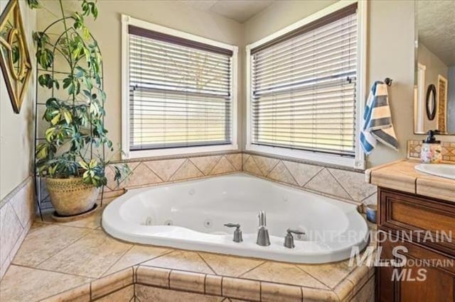 bathroom with a jetted tub and vanity