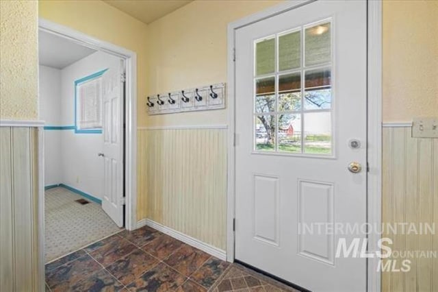 doorway with a wainscoted wall