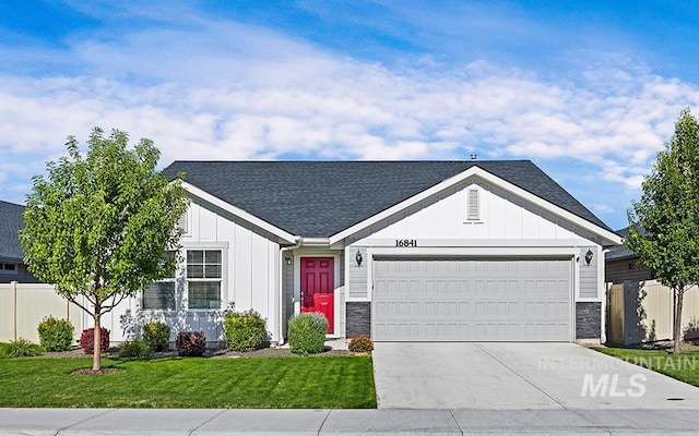 single story home with a front yard and a garage