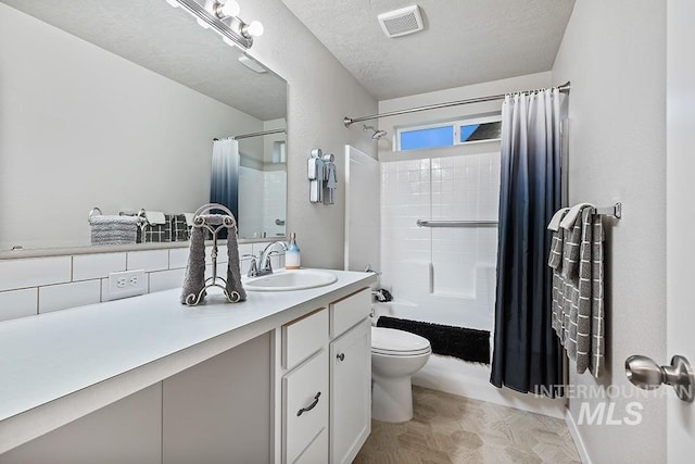 full bathroom with vanity, toilet, shower / bathtub combination with curtain, and a textured ceiling