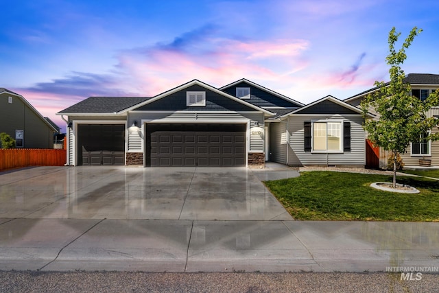 12850 Conner St, Caldwell, ID 83607 - view of front of home featuring an attached garage, driveway, and stone siding