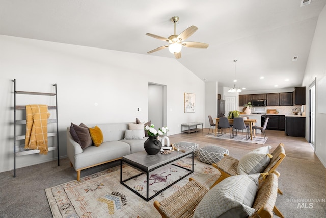 12850 Conner St, Caldwell, ID 83607 - living room featuring vaulted ceiling, a ceiling fan, a chandelier, recessed lighting, and light colored carpet