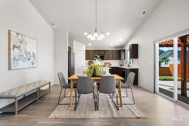 12850 Conner St, Caldwell, ID 83607 - dining area with a chandelier, light wood-type flooring, recessed lighting, and vaulted ceiling
