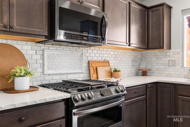 12850 Conner St, Caldwell, ID 83607 - kitchen with appliances with stainless steel finishes, dark brown cabinets, and tasteful backsplash