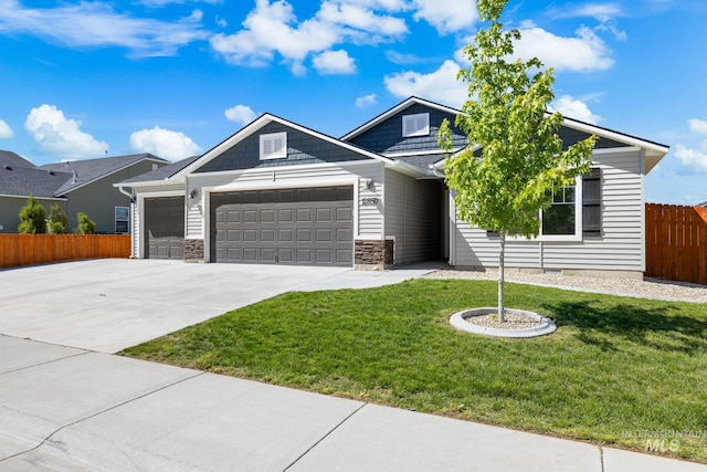 12850 Conner St, Caldwell, ID 83607 - view of front of house with a garage, concrete driveway, and stone siding
