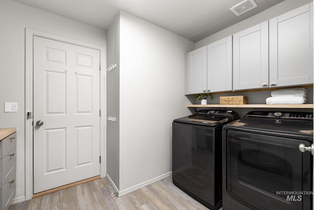 12850 Conner St, Caldwell, ID 83607 - laundry room with washer and dryer, cabinet space, light wood-style floors, and baseboards
