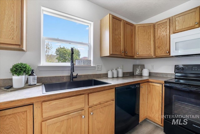 1471 Wrangler St, Twin Falls, ID 83301 - kitchen with black appliances, a sink, light countertops, and wood finished floors