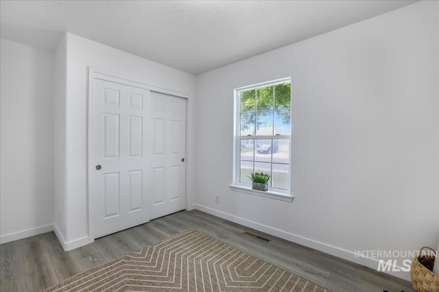 1471 Wrangler St, Twin Falls, ID 83301 - unfurnished bedroom with wood finished floors, baseboards, and a closet