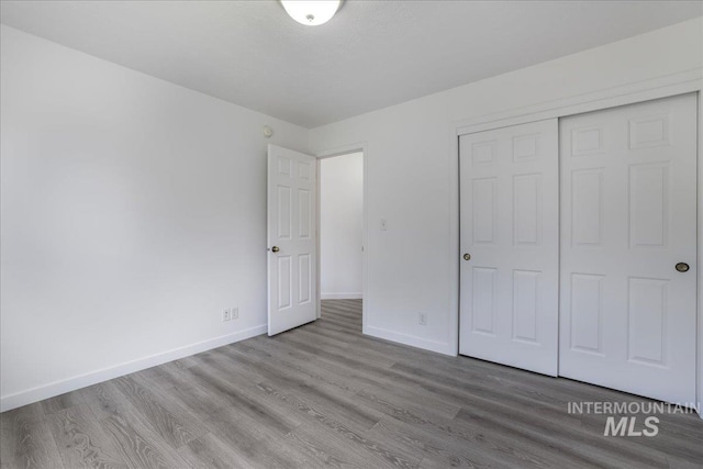 1471 Wrangler St, Twin Falls, ID 83301 - unfurnished bedroom featuring wood finished floors, baseboards, and a closet
