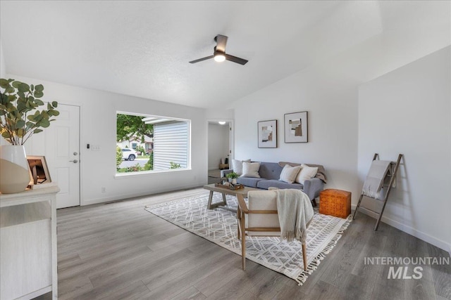 1471 Wrangler St, Twin Falls, ID 83301 - living area featuring vaulted ceiling, a ceiling fan, wood finished floors, and baseboards