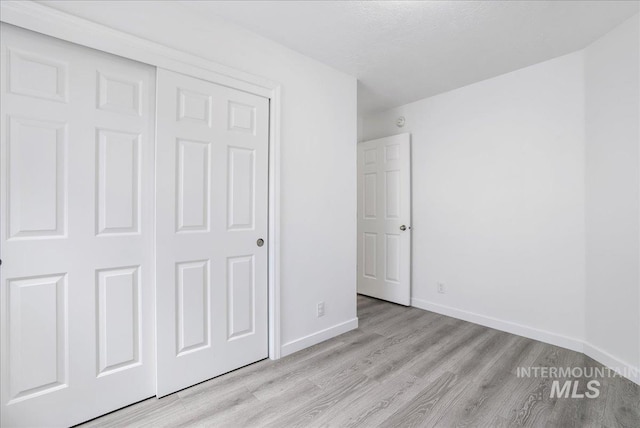 1471 Wrangler St, Twin Falls, ID 83301 - unfurnished bedroom with light wood-type flooring, baseboards, and a closet