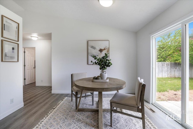 1471 Wrangler St, Twin Falls, ID 83301 - dining area featuring vaulted ceiling, wood finished floors, and baseboards