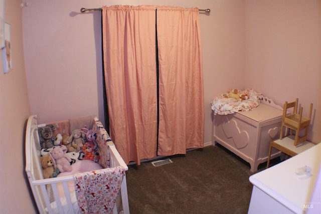 bedroom with dark colored carpet