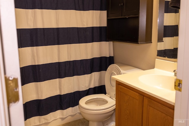 bathroom with tile patterned floors, vanity, and toilet